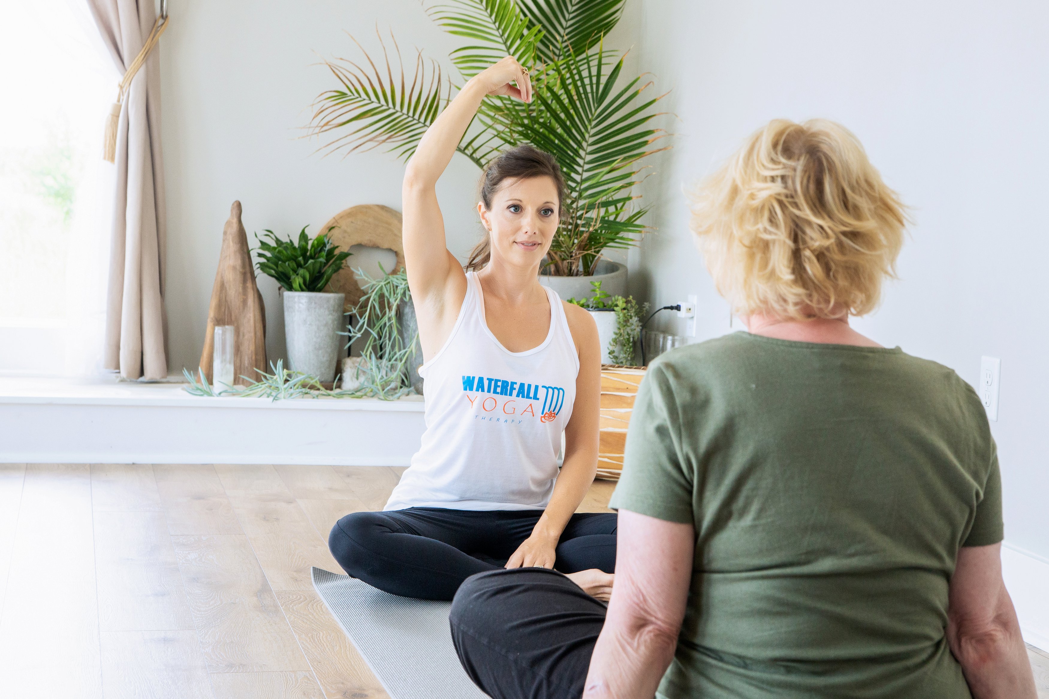 Yoga instructor giving instructions to a client
